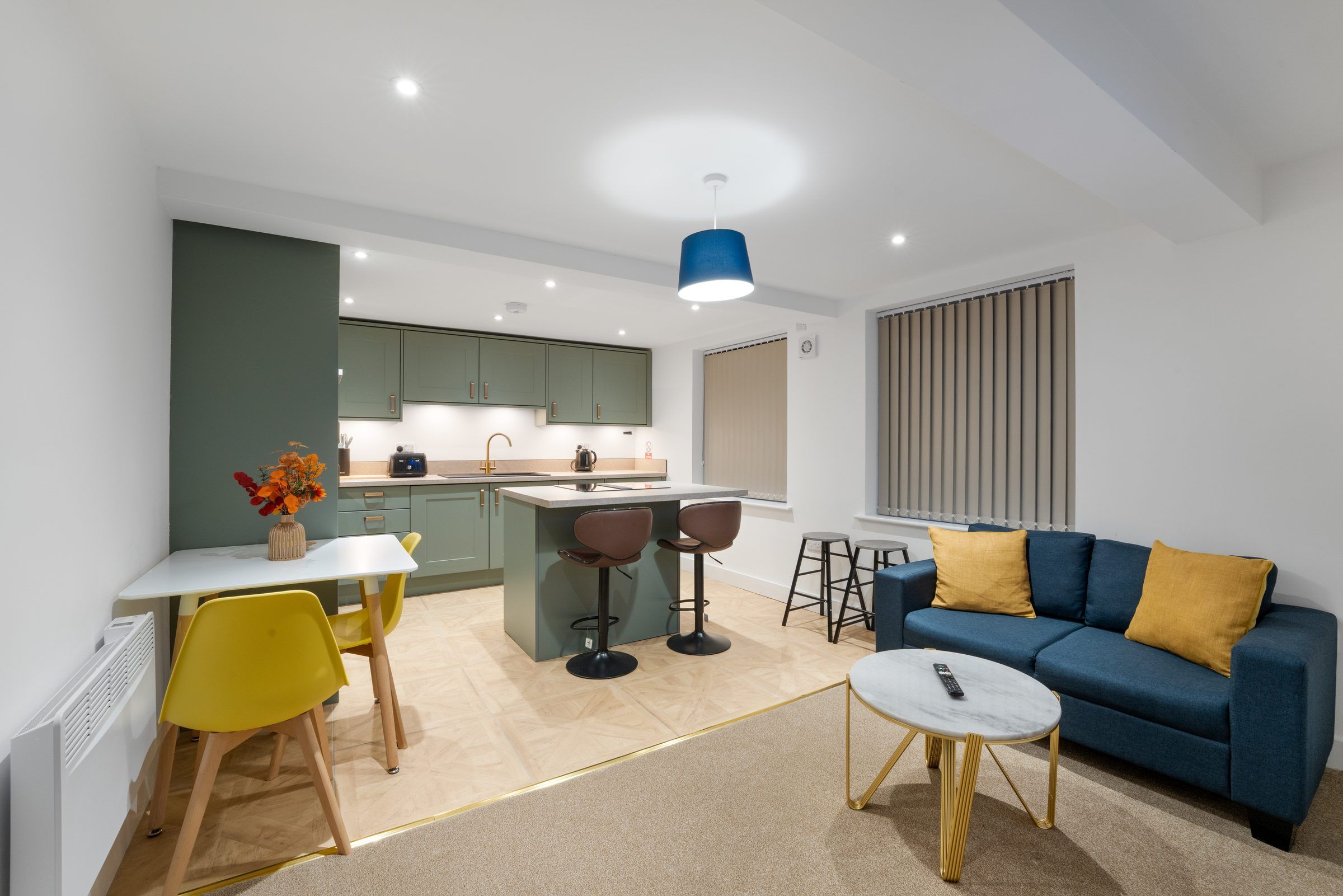 Open-plan apartment with kitchen, dining area and sofa