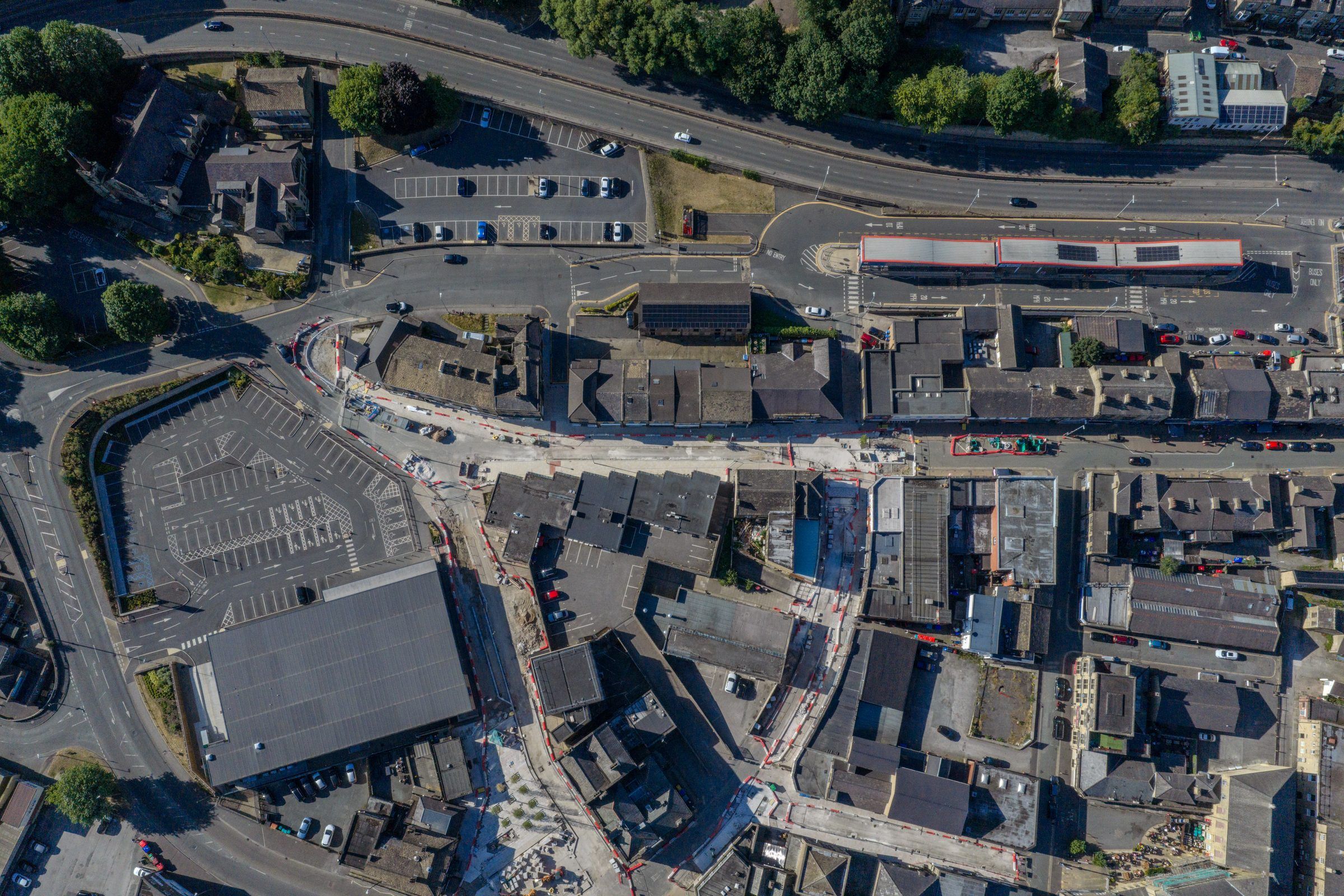 Top-down view of a town with roads, car parks and trees