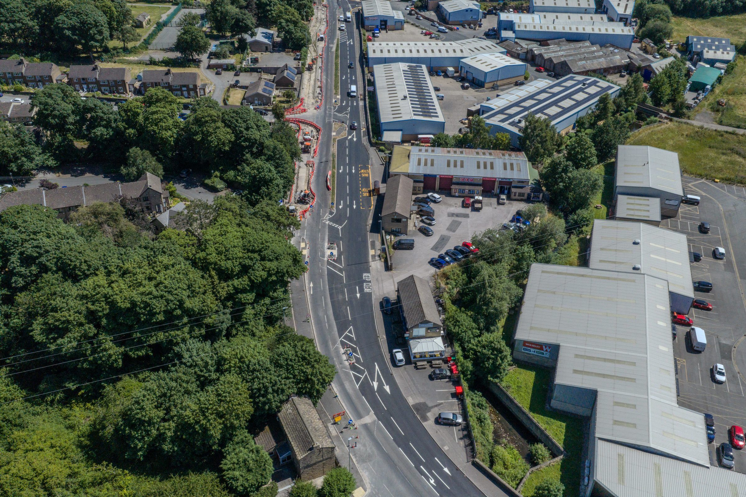 Aerial of a road through an industrial estate and woodland