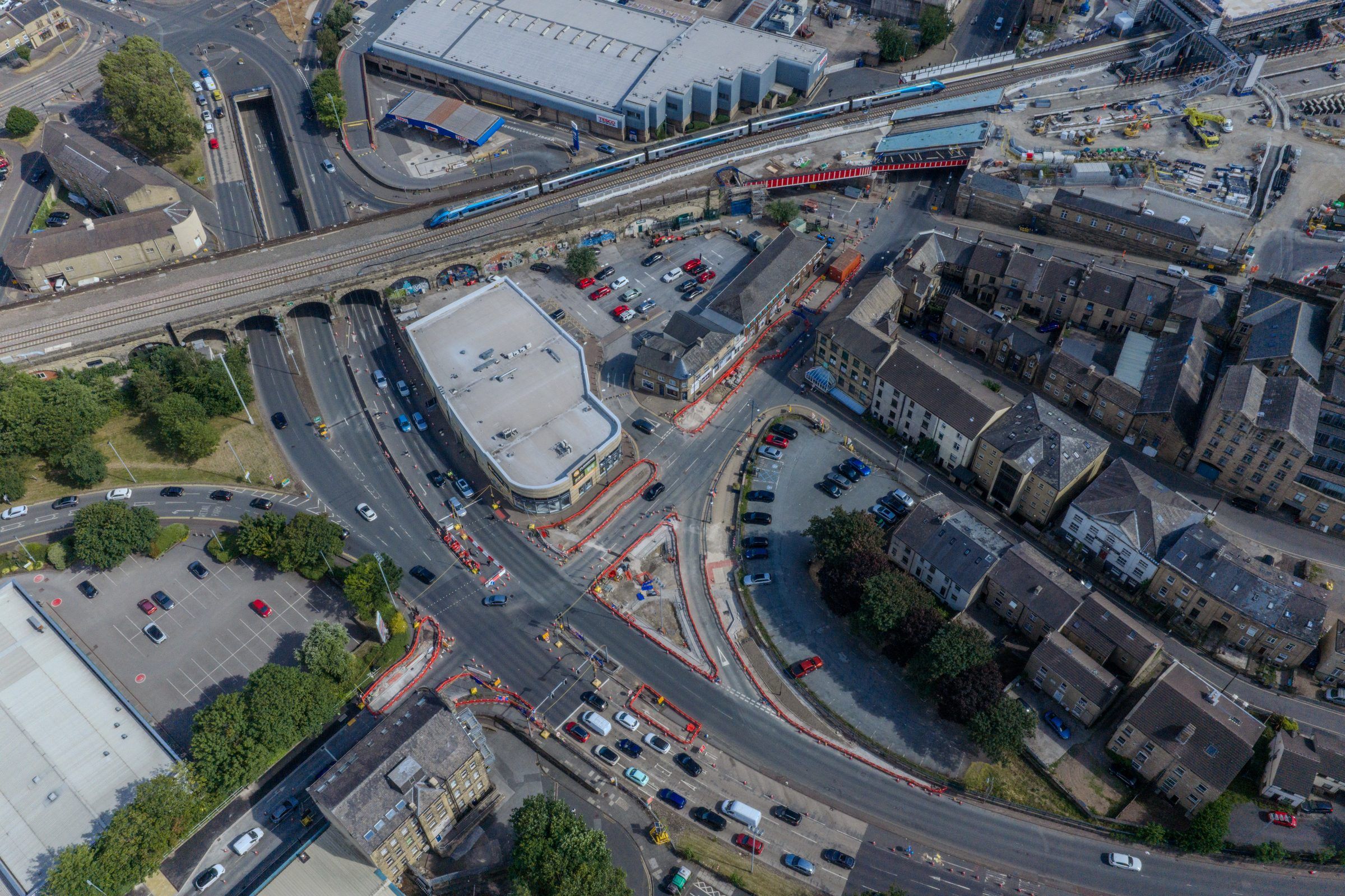 Aerial view of a road junction beside a railway viaduct