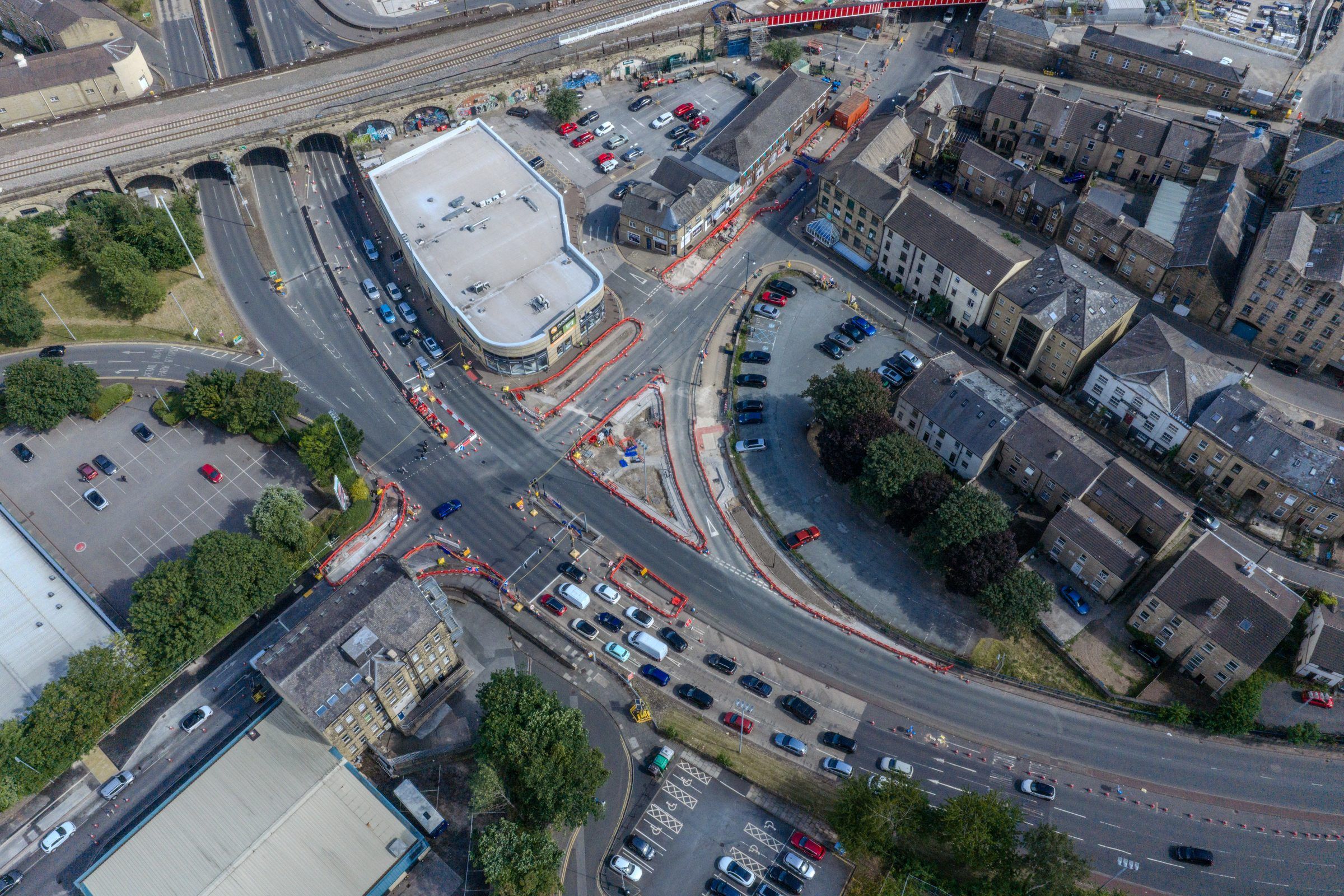 Aerial of a curved road, railway viaduct and terraced streets